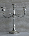 Vintage Italian silver plated three arm candelabra from the 1970s on stone surface