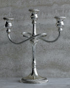 Vintage Italian silver plated three arm candelabra from the 1970s on stone surface