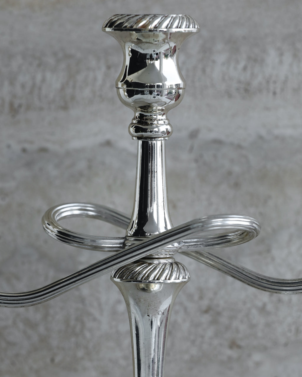 Close-up of central column and sculptural arms of Italian silver plated candelabra