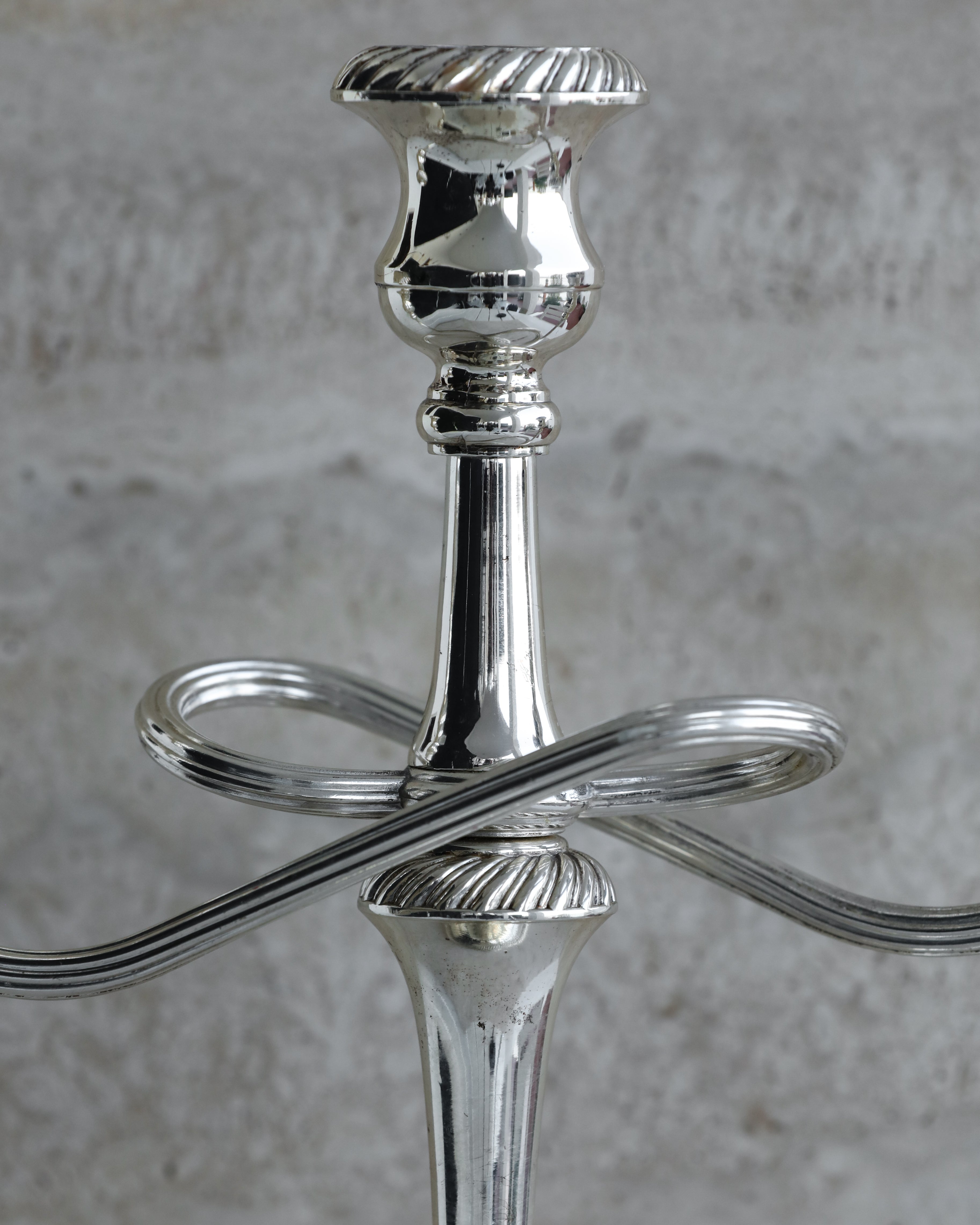 Close-up of central column and sculptural arms of Italian silver plated candelabra