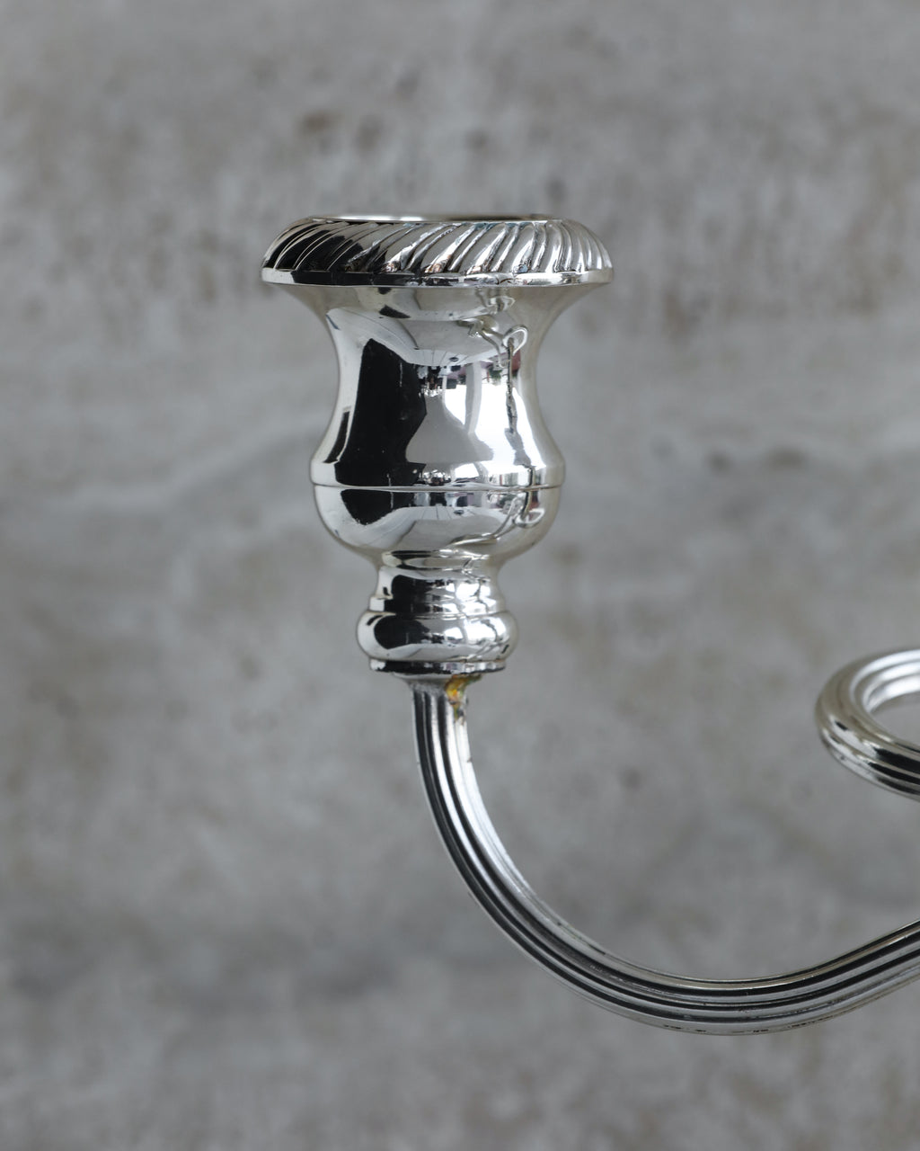Detailed view of fluted candle cup on vintage Italian three arm candelabra