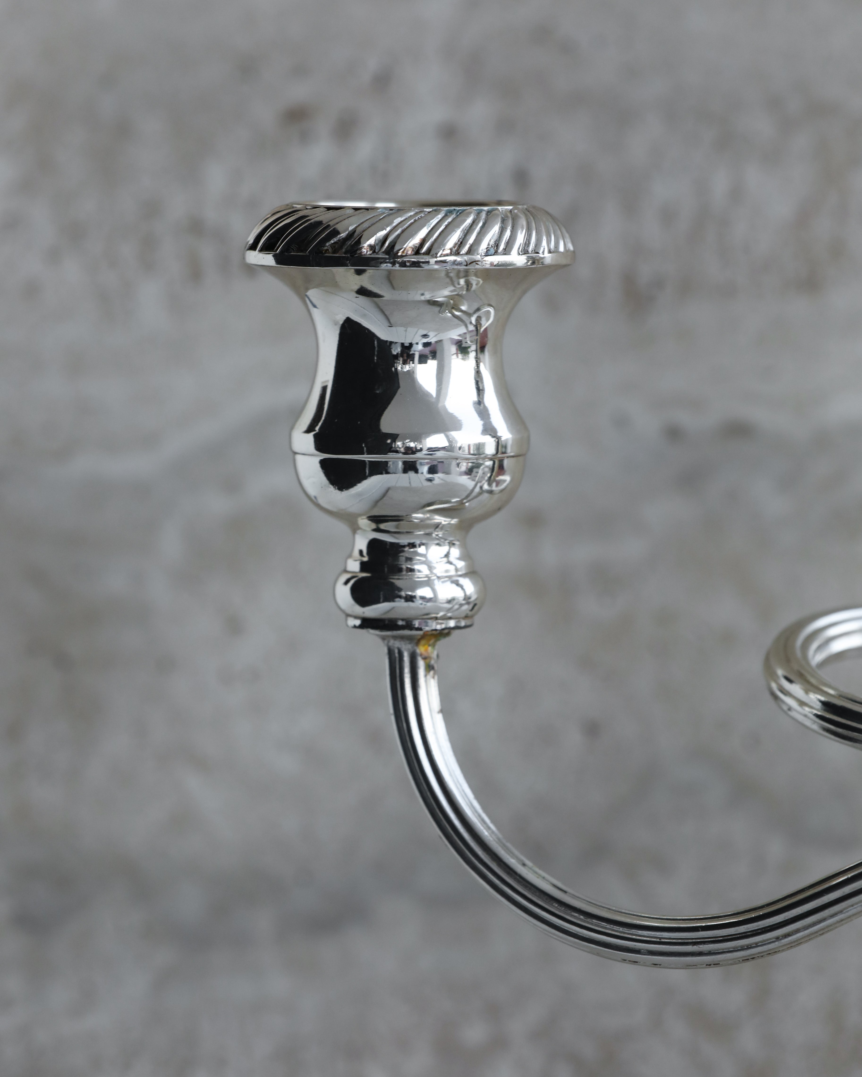 Detailed view of fluted candle cup on vintage Italian three arm candelabra