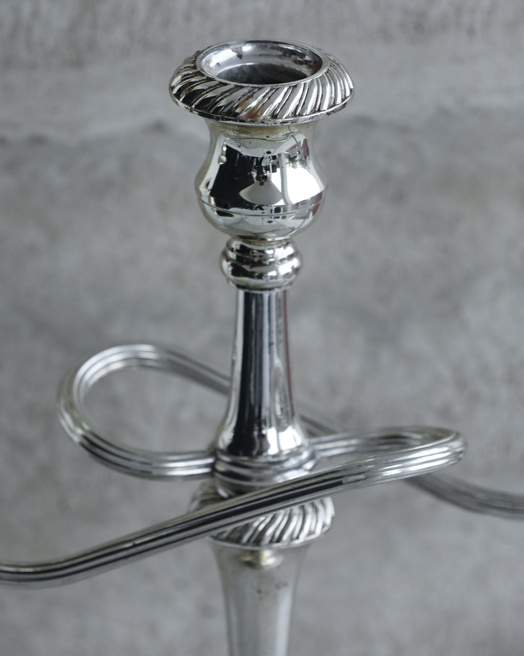 Top view of candle cup with fluted rim on vintage silver plated candelabra