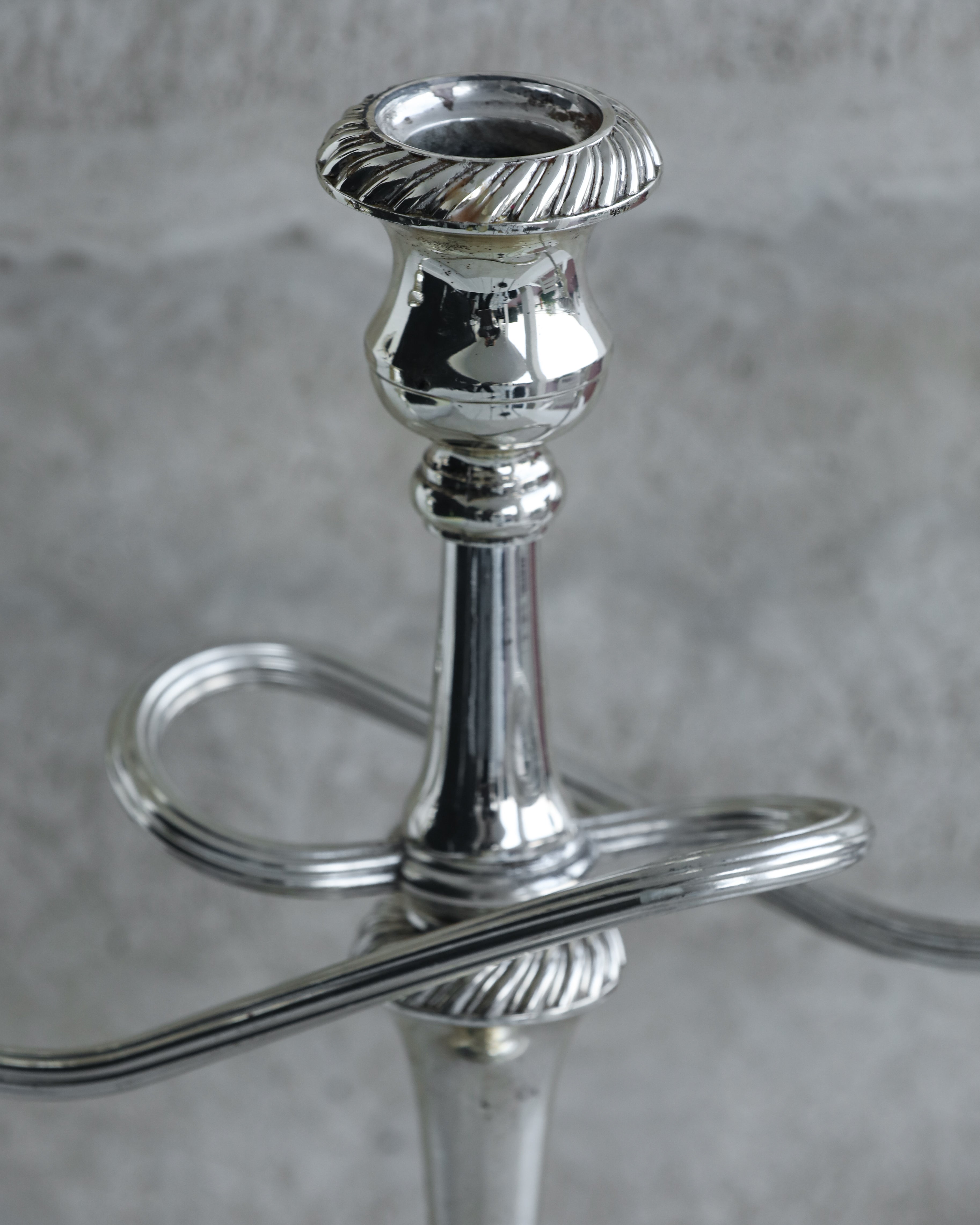 Top view of candle cup with fluted rim on vintage silver plated candelabra