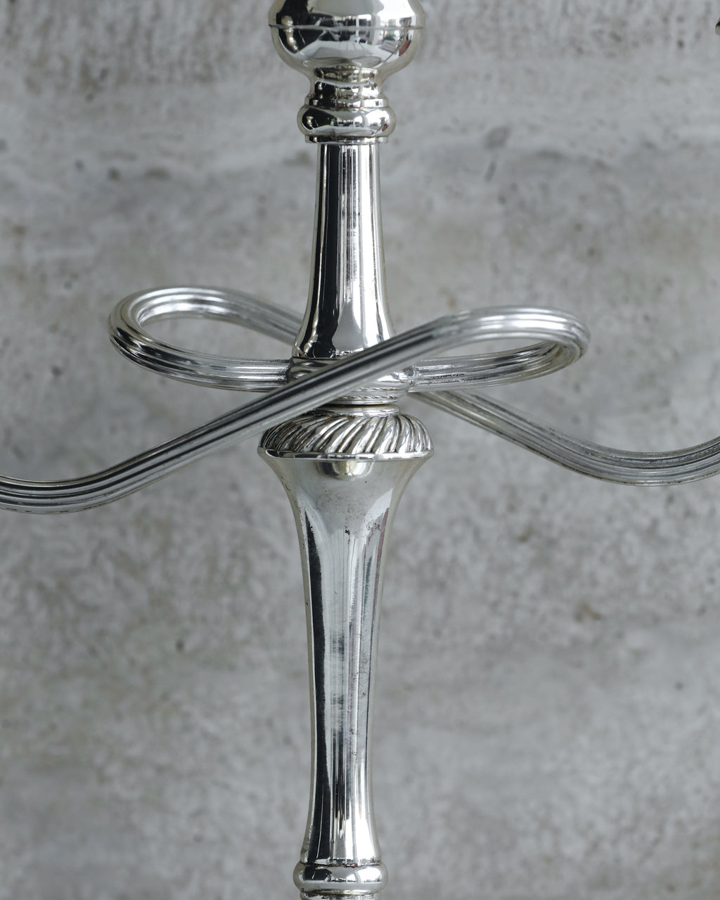 Close-up of twisted arm detail and central stem of 1970s Italian candelabra