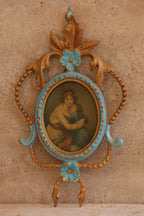 Close-up of ornate Italian brass picture frame with hand-painted miniature portrait in rococo floral design