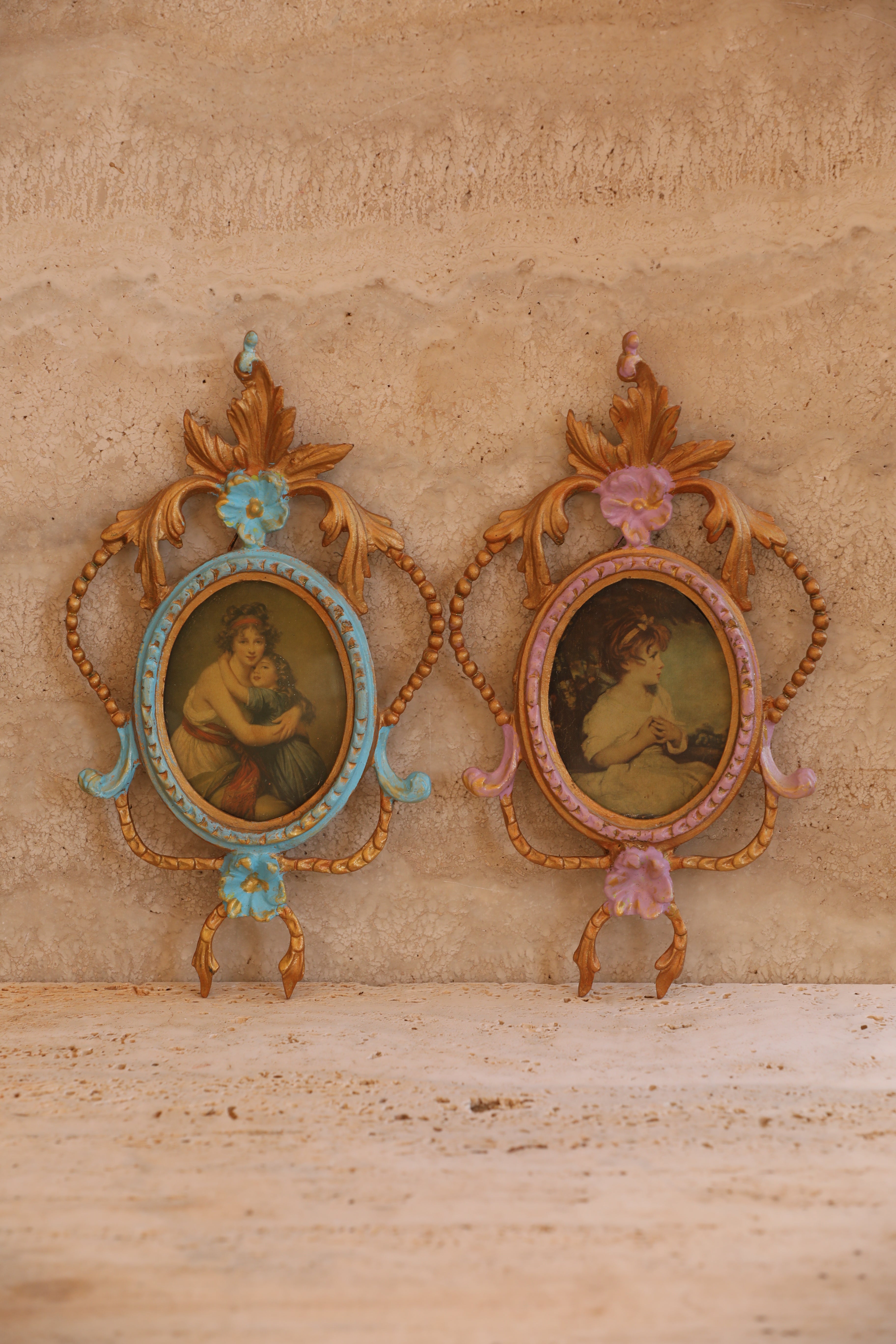 Pair of antique Italian portrait frames in turquoise and lilac with baroque scrollwork and gold accents