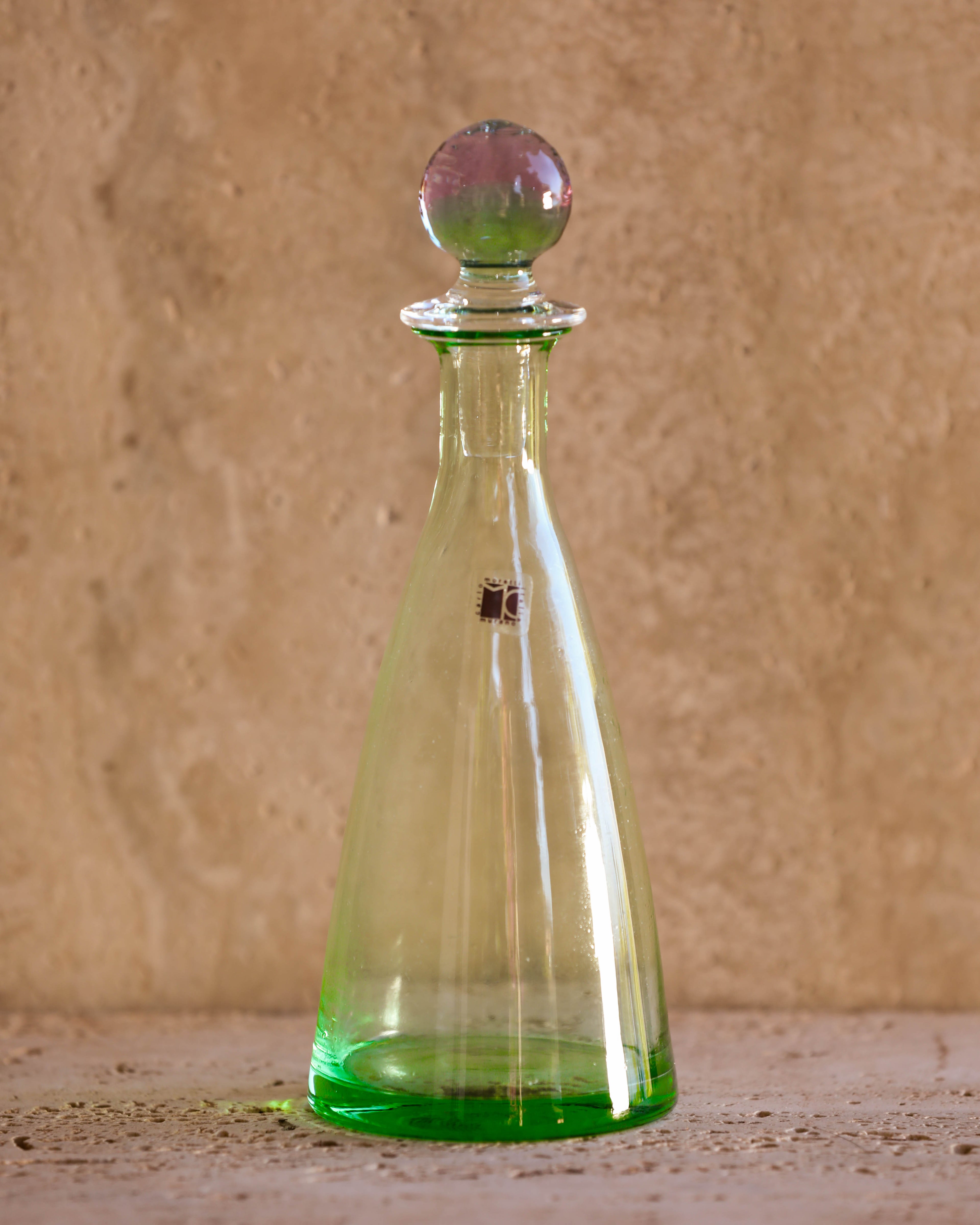 Front view of Carlo Moretti 1970s Murano glass perfume bottle in translucent green with spherical stopper