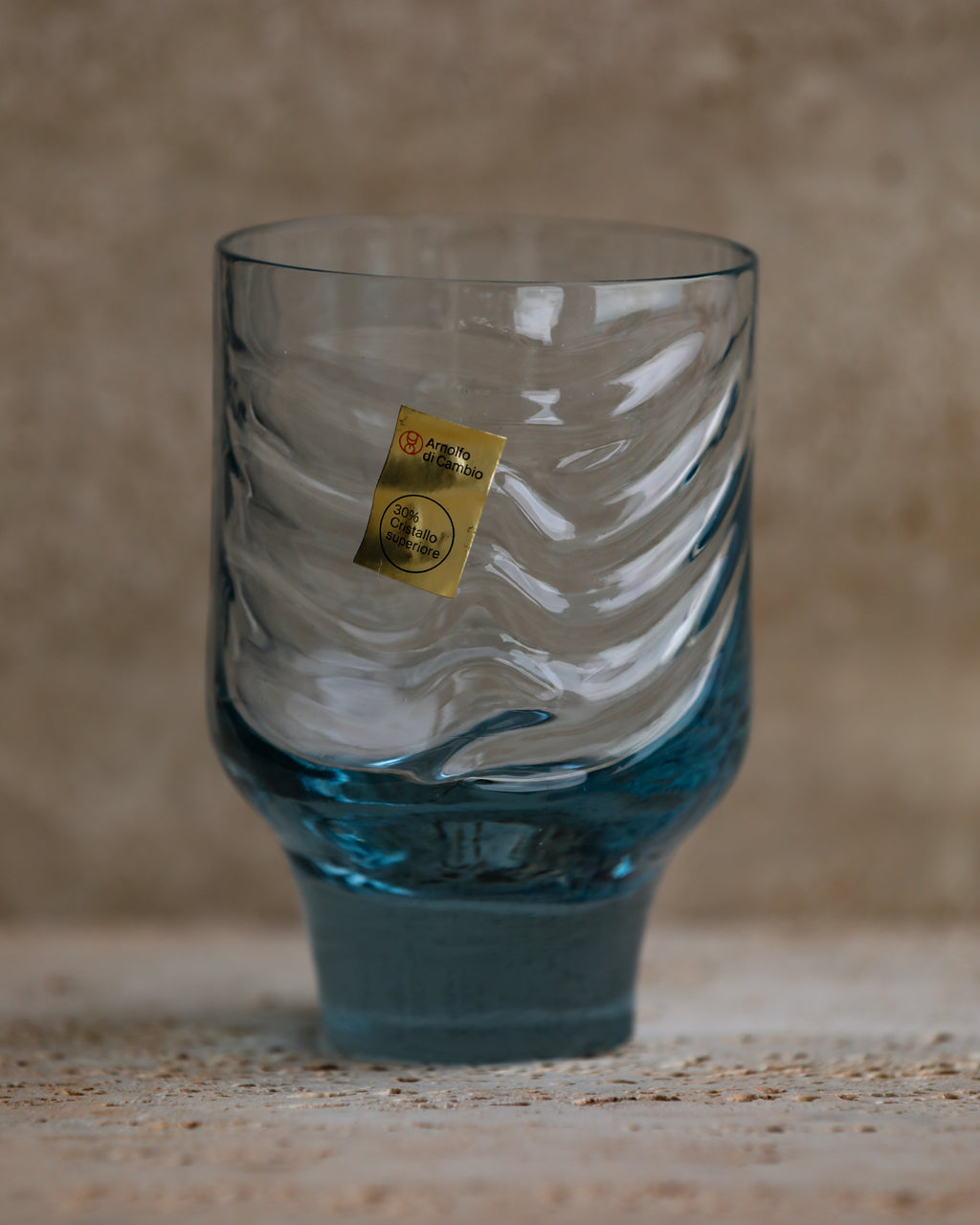 Front view of vintage Italian cobalt blue tumbler with ribbed texture and 30% crystal sticker.