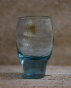 Textured cobalt blue tumbler with rounded top and tapered base.