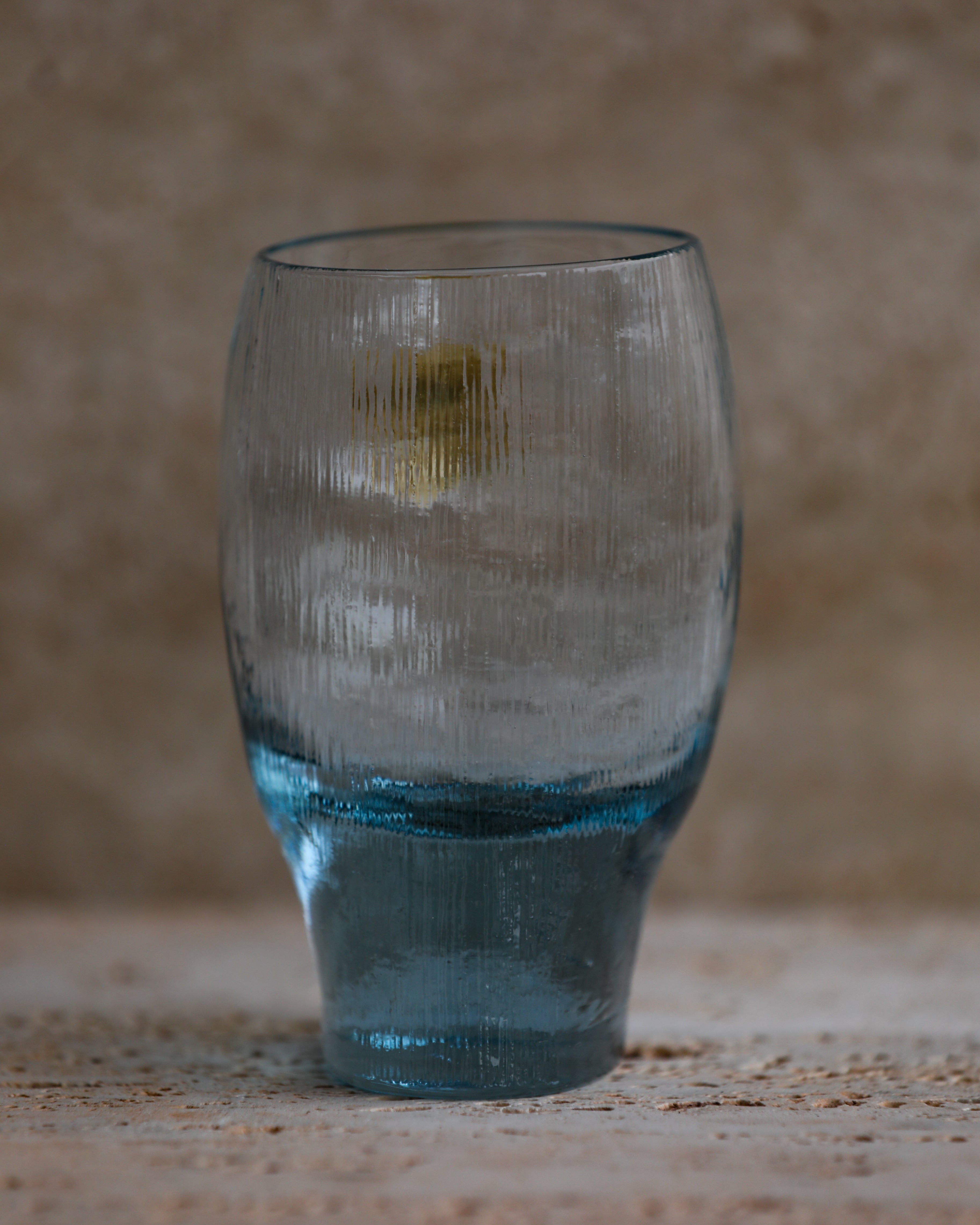 Textured cobalt blue tumbler with rounded top and tapered base.