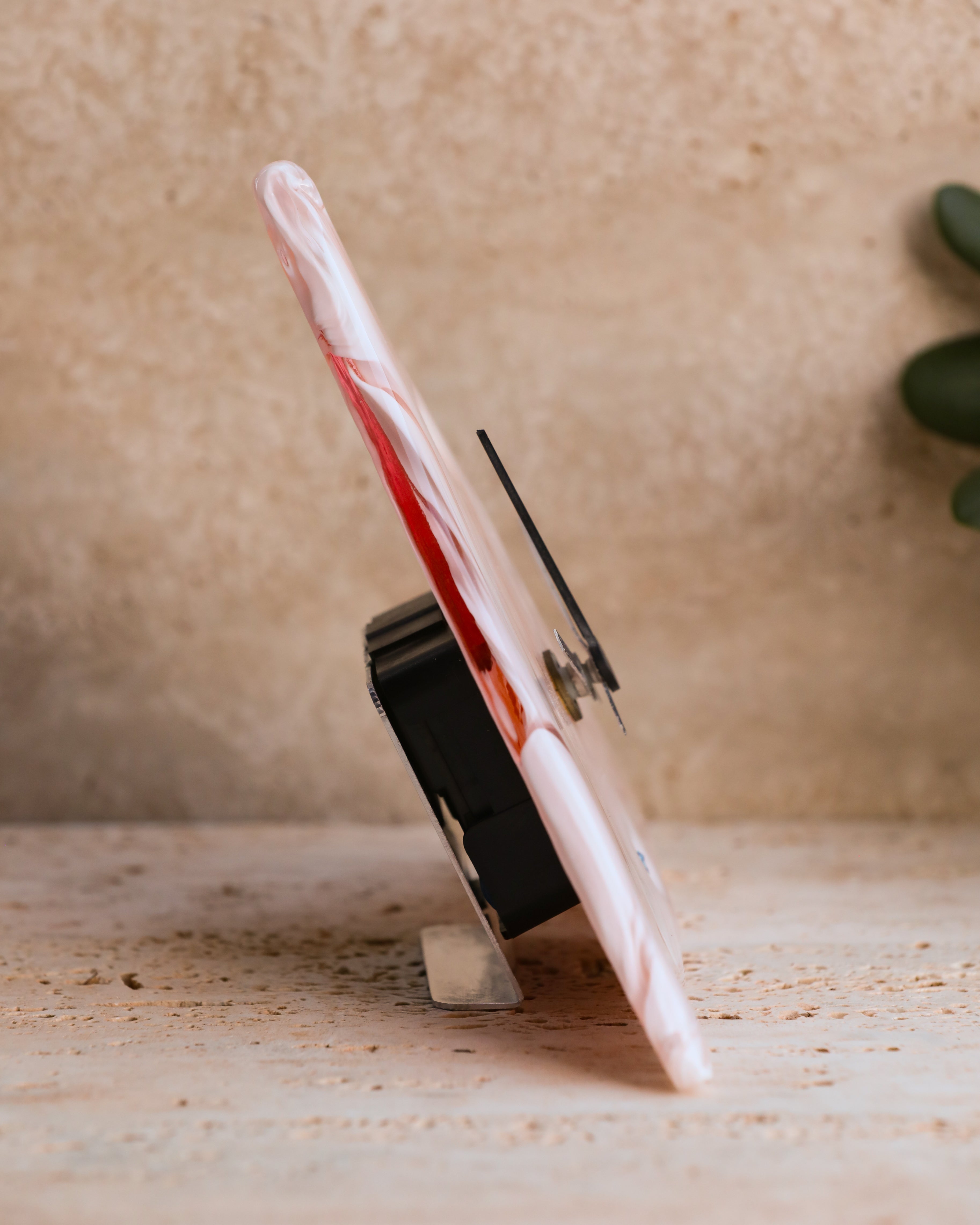 Side profile of triangular pink Murano glass clock showing thickness and craftsmanship