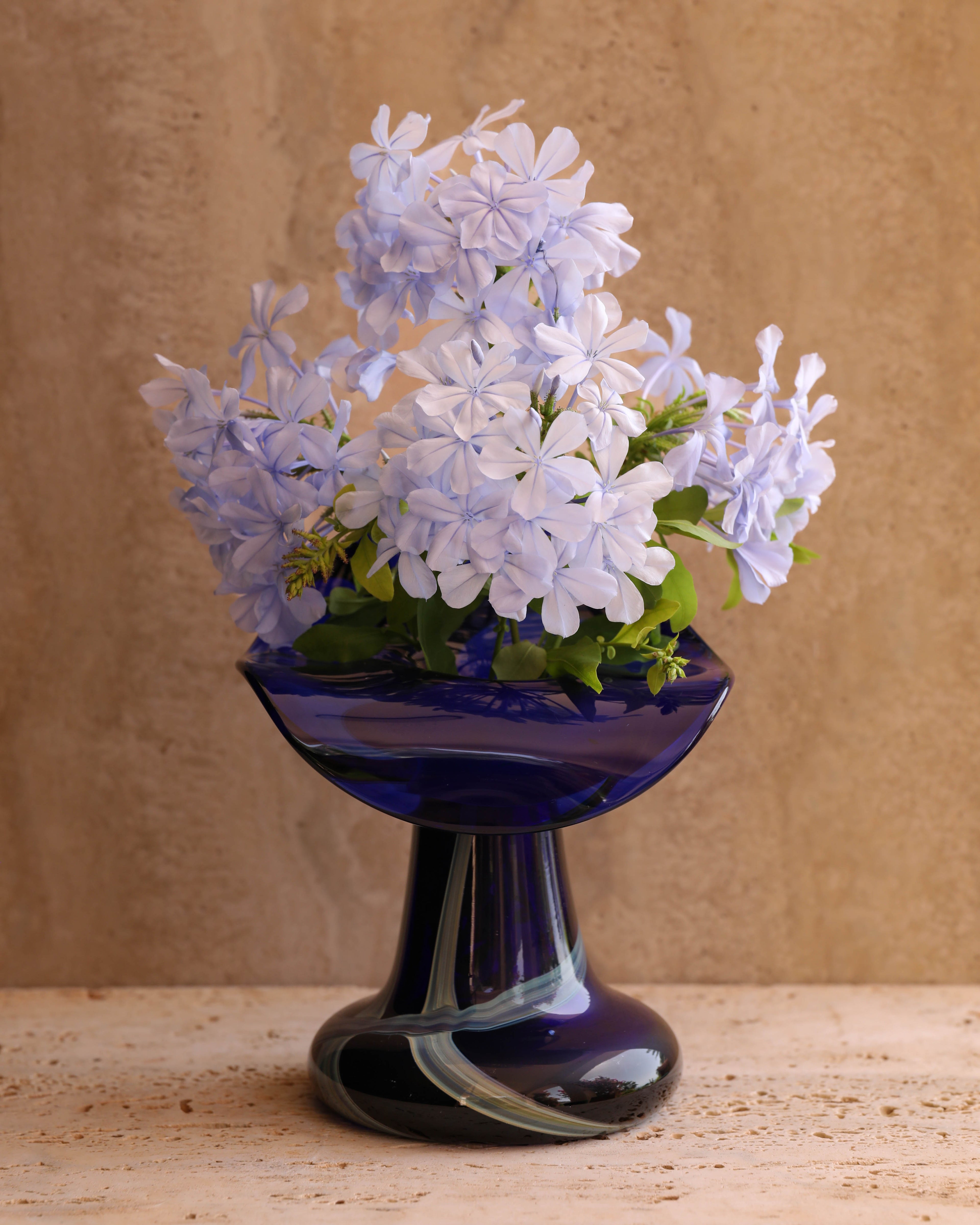 Vintage Italian art glass vase styled on travertine surface