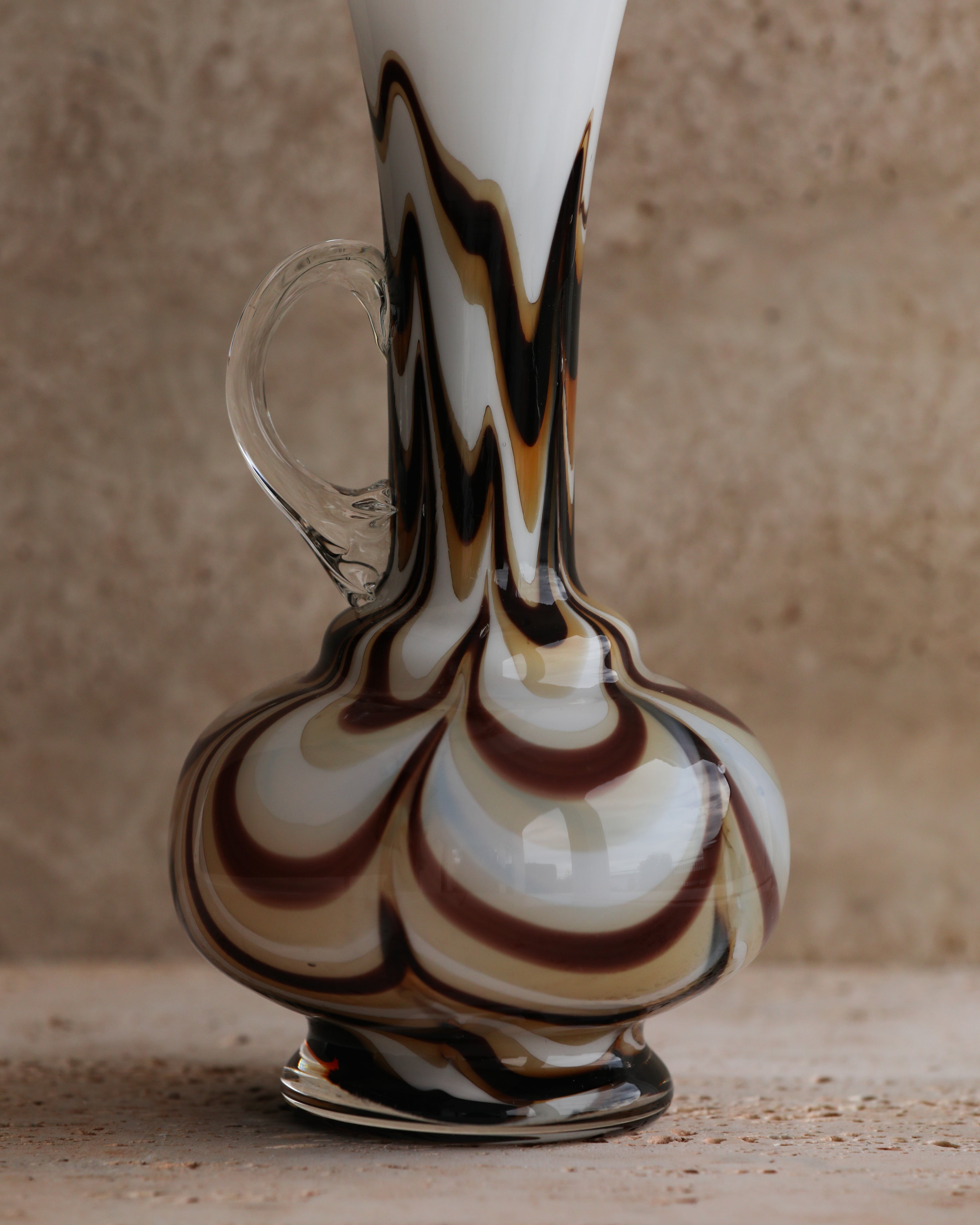 Close-up of the pitcher’s spiral pattern base showing sculptural glass patterning.