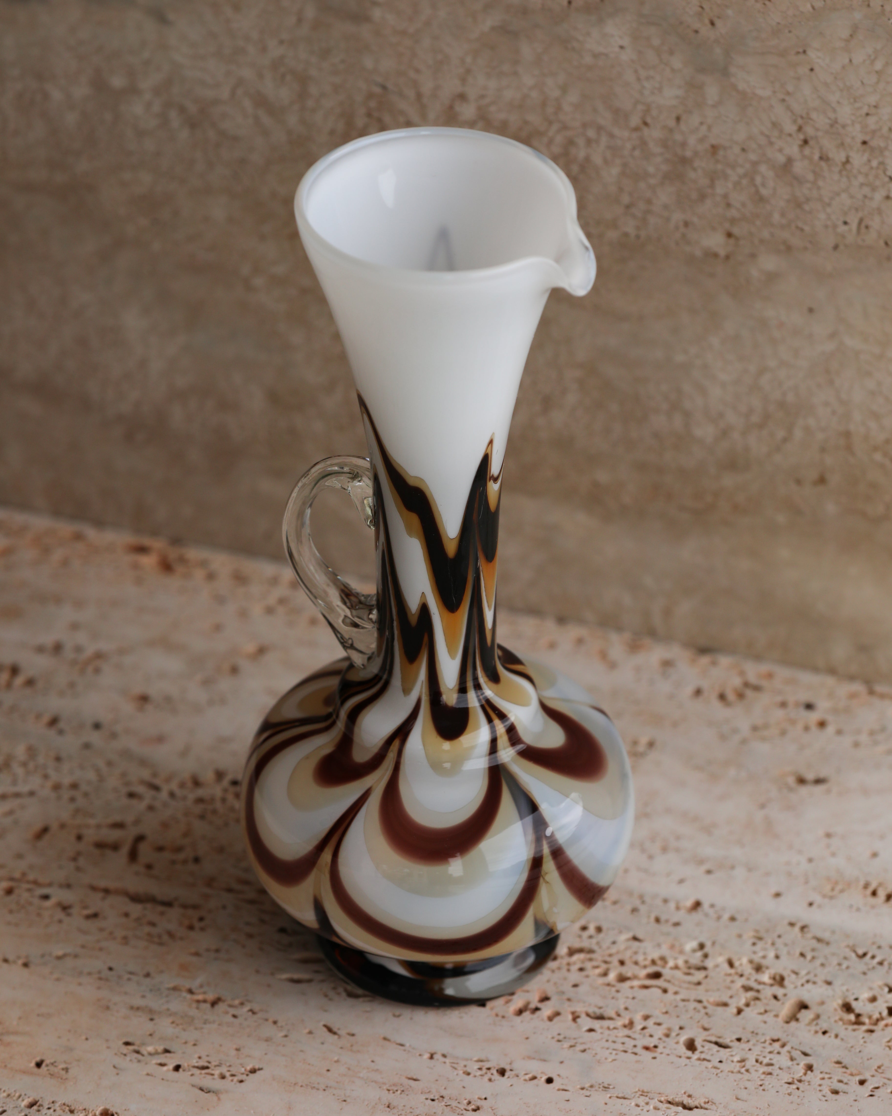 Angled view of the tall marbled Murano glass pitcher displaying handle and shape.