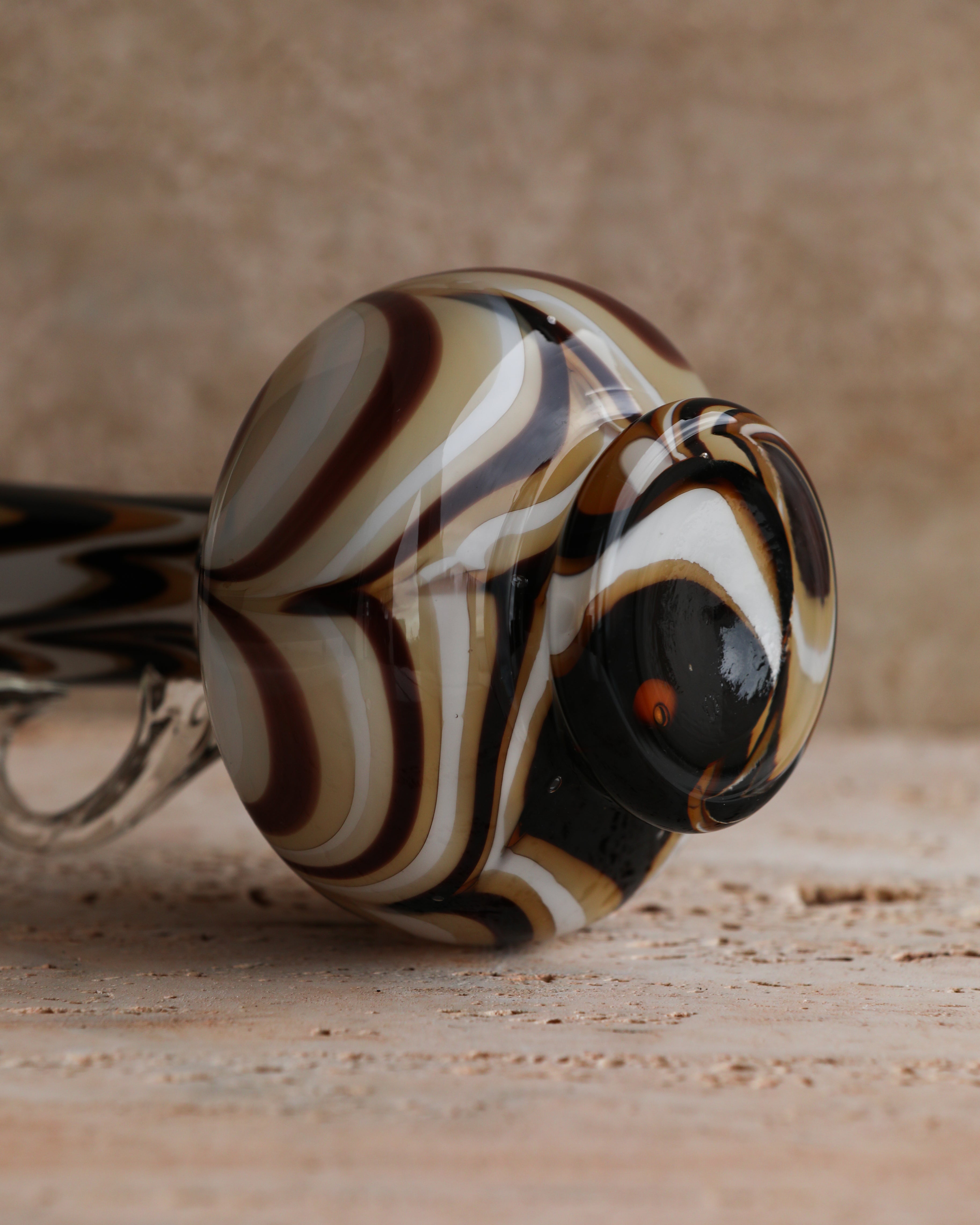 Bottom of the pitcher showing the layered brown, amber, white, and black Murano glass design.