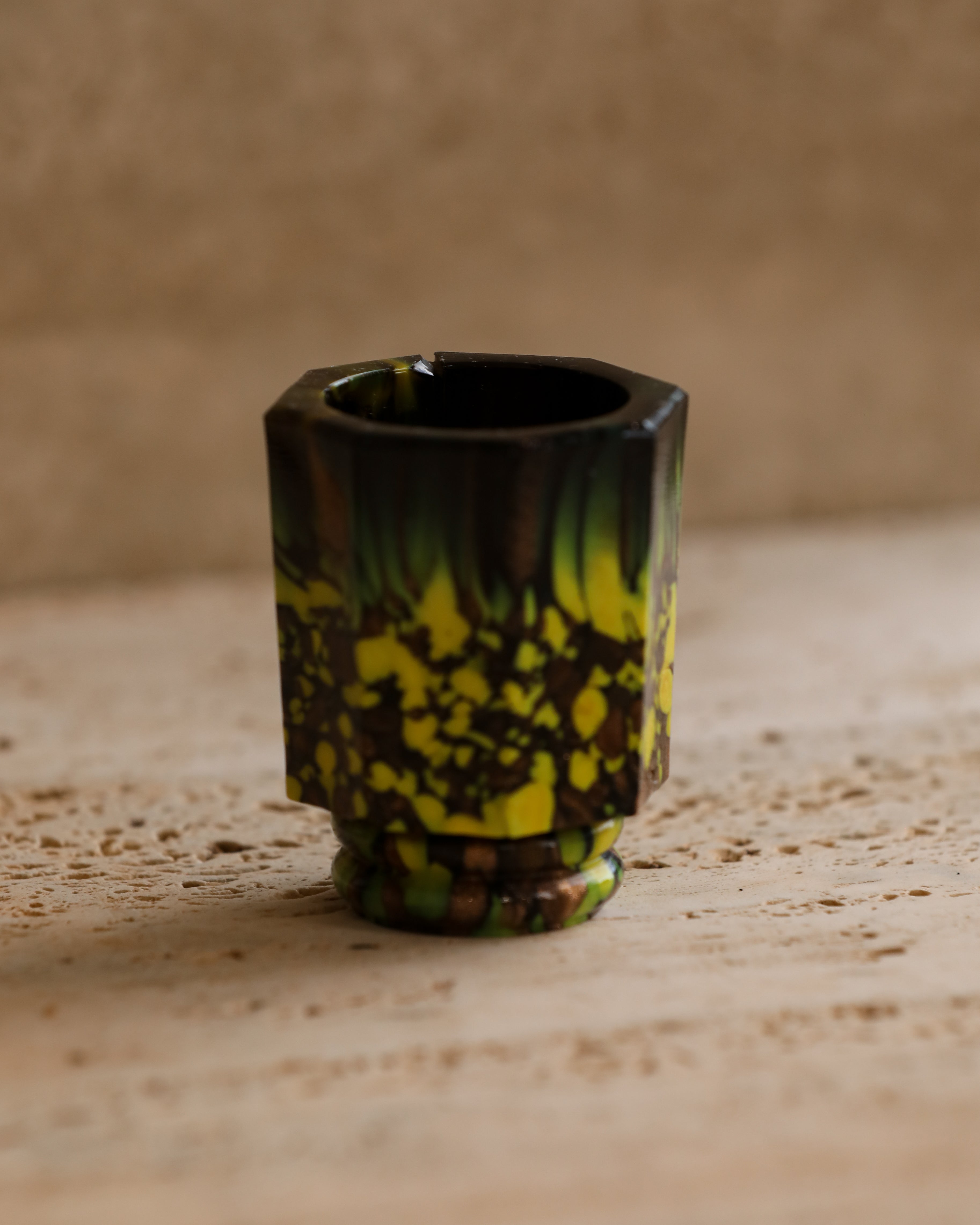 Side angle of Murano mold-blown shot glass showing octagonal shape and thick glass texture — 1970s Italian design