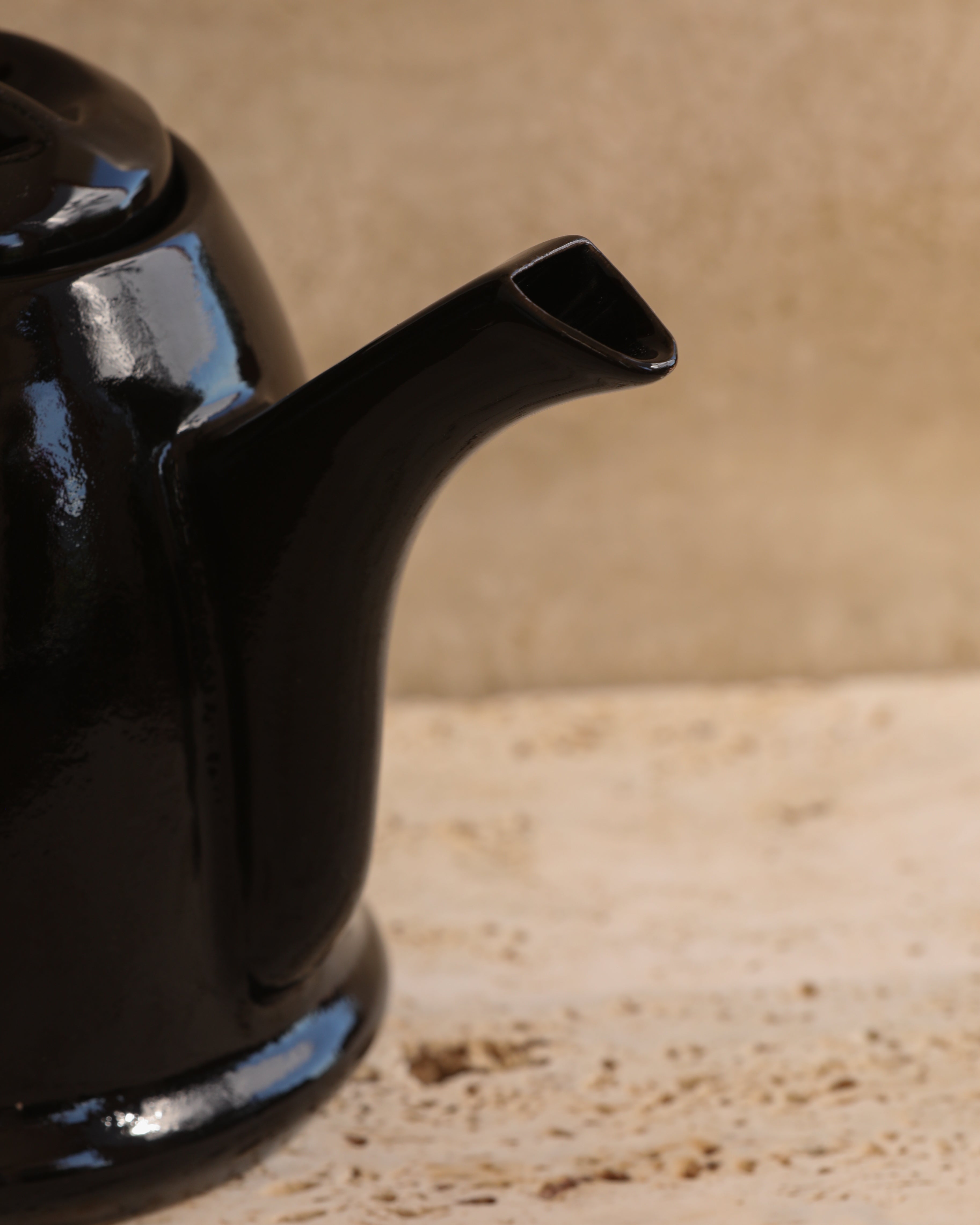 Close-up of black glazed ceramic teapot spout and handle, Portuguese pottery