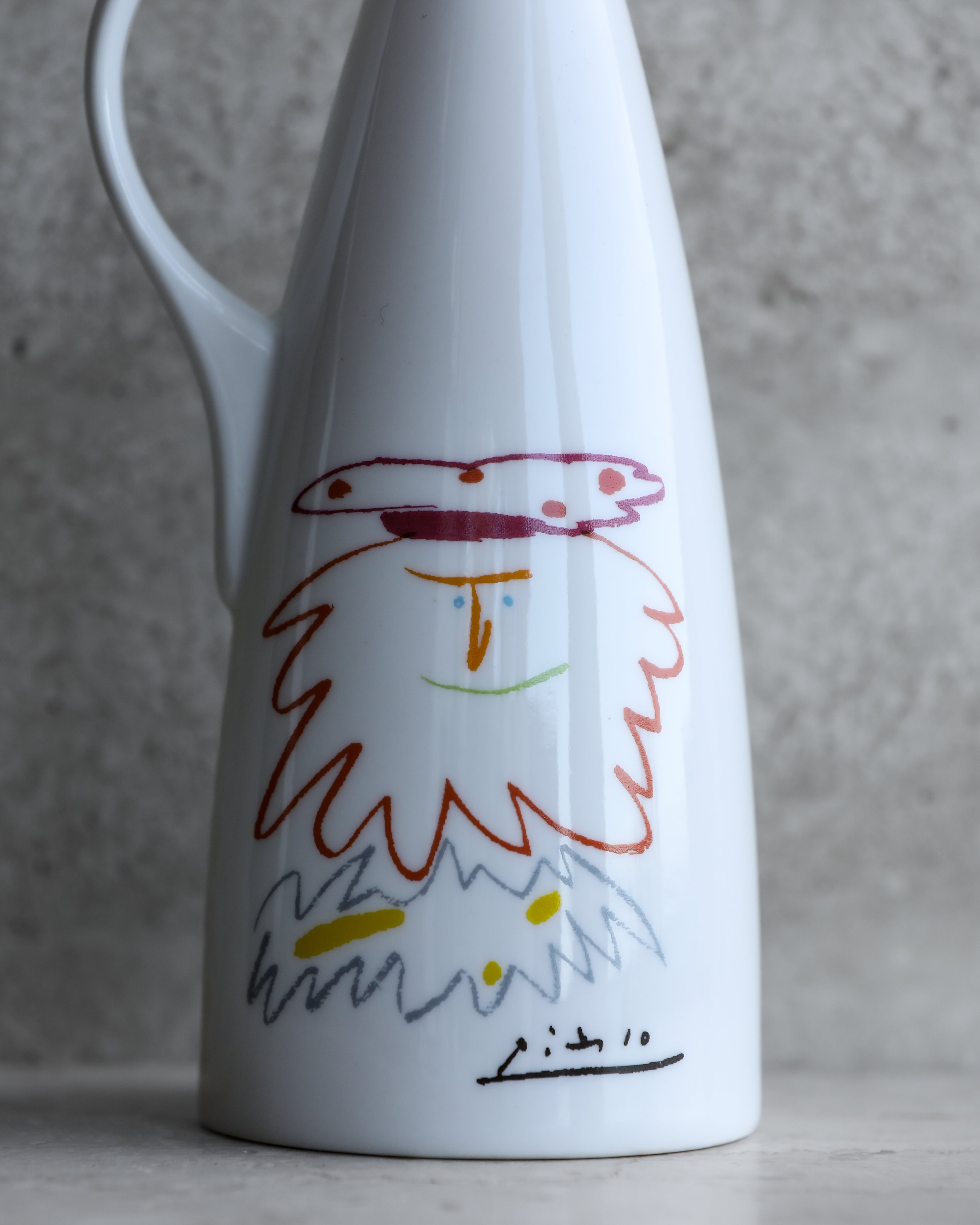 Close-up of Picasso face illustration on porcelain bottle