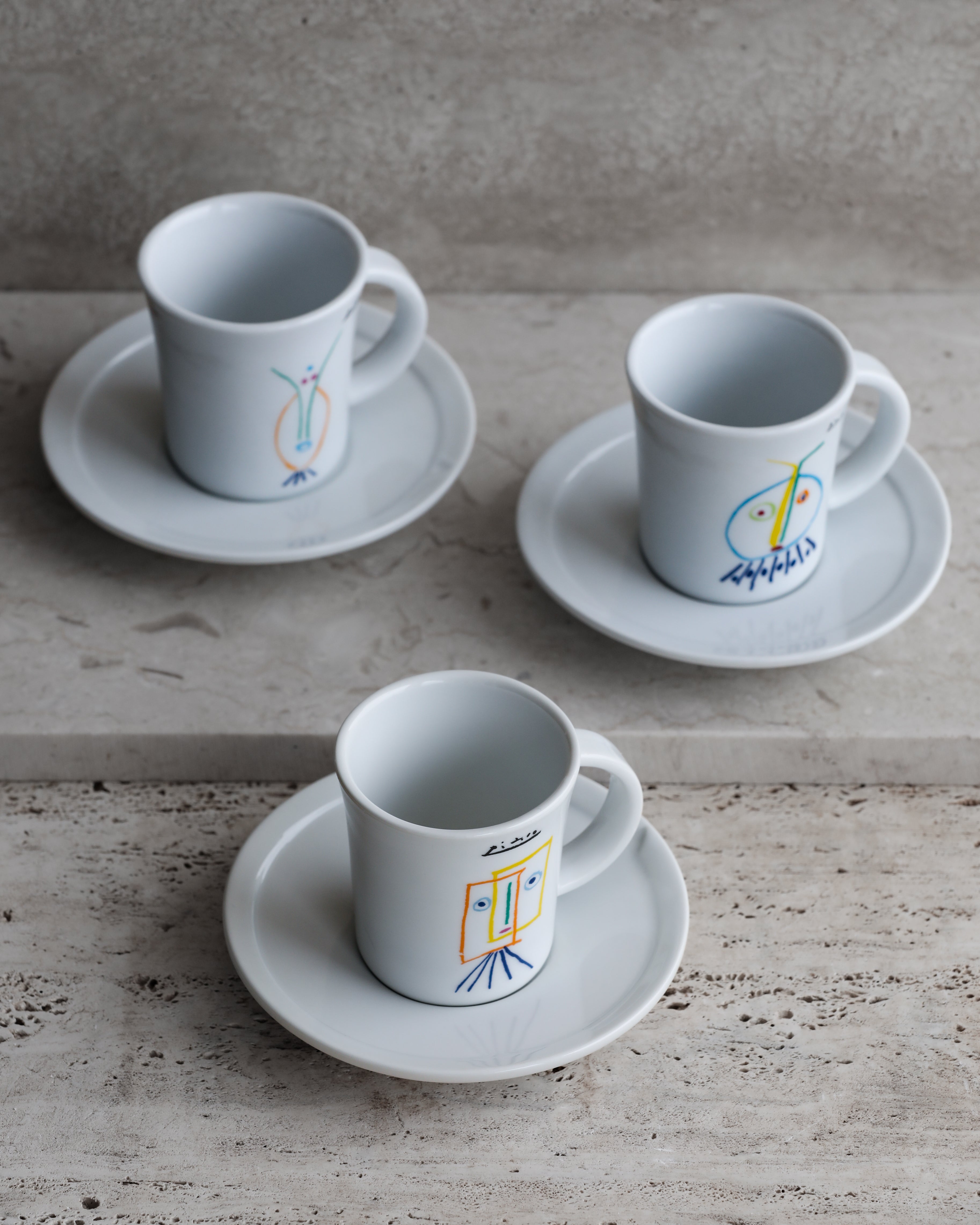 Picasso x Tognana porcelain espresso cups with saucers arranged on stone surface