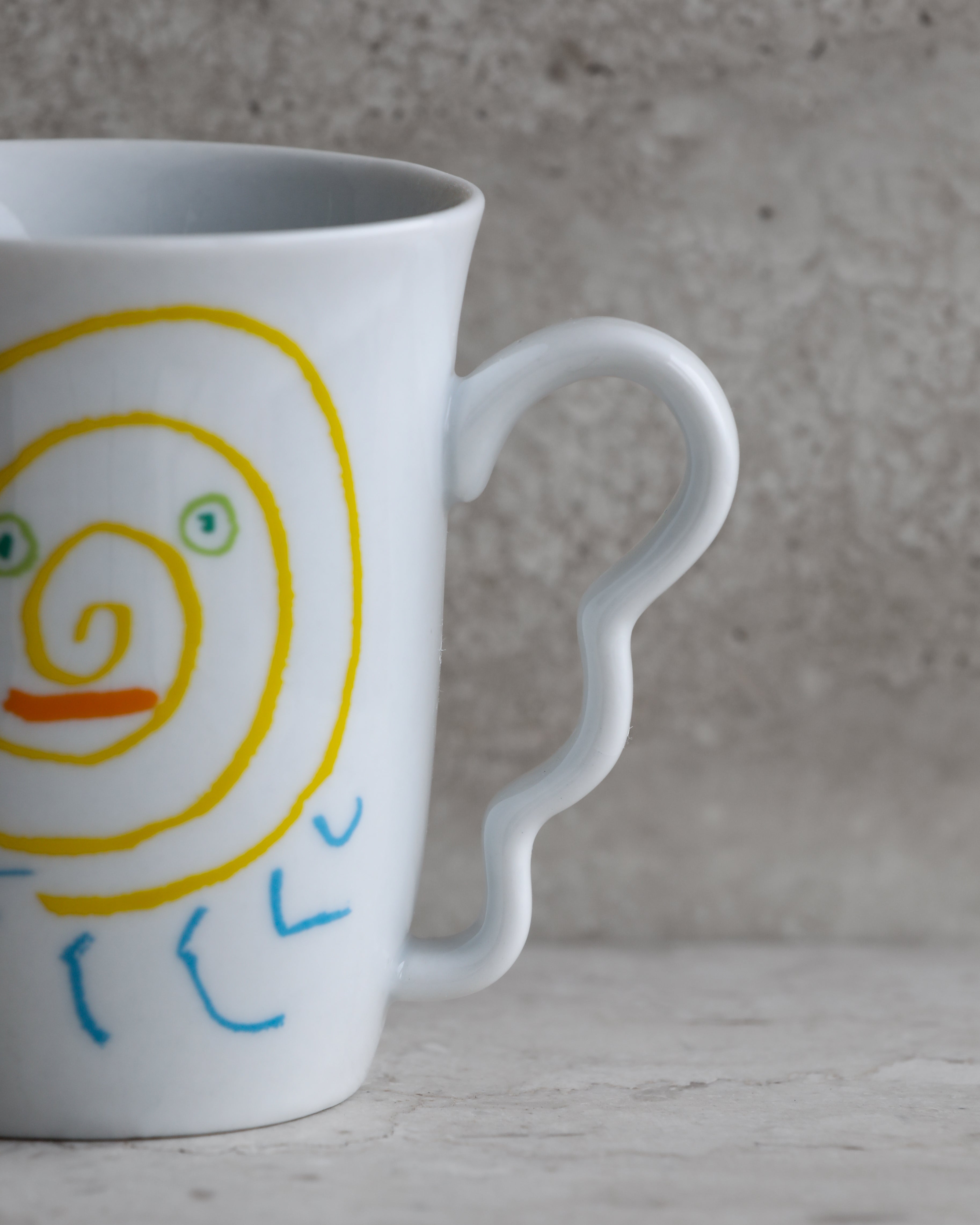 Close-up of sculptural wavy handle on Picasso Tognana porcelain mug